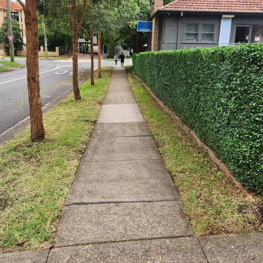 After: freshly mowed nature strip and squared-off hedge along the same Hills District footpath